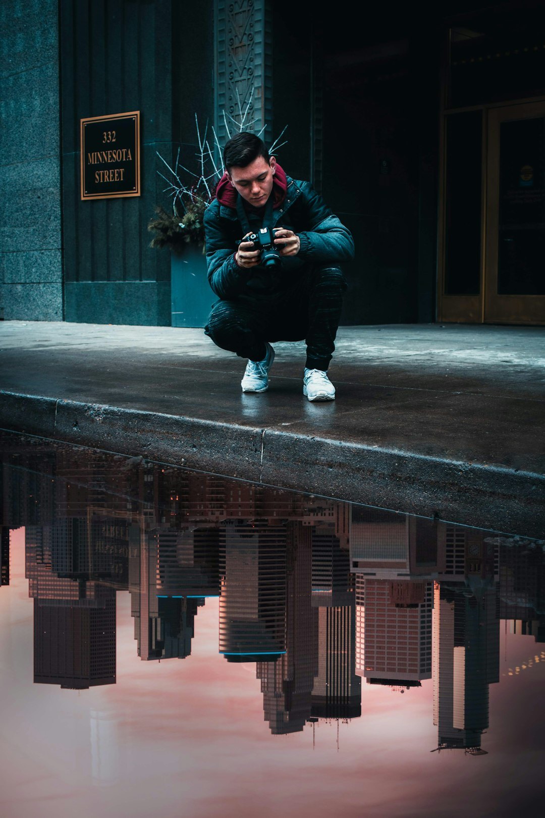 Photographer crouching to take a photo on a city street