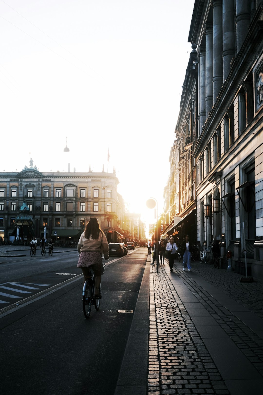 Person cycling through a Copenhagen street